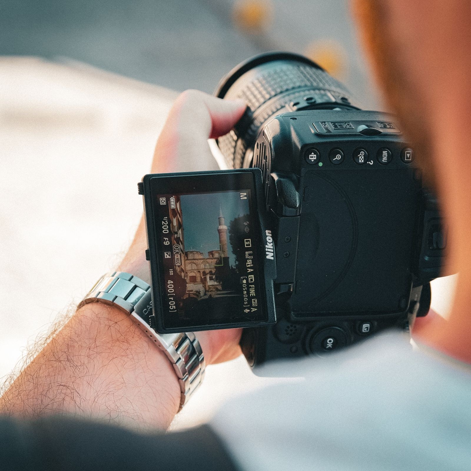 Editor framing a shot with a camera on location